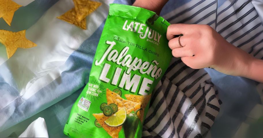 hand holding Late July Snacks Jalapeno Lime Tortilla Chips, 7.8 OZ Bag