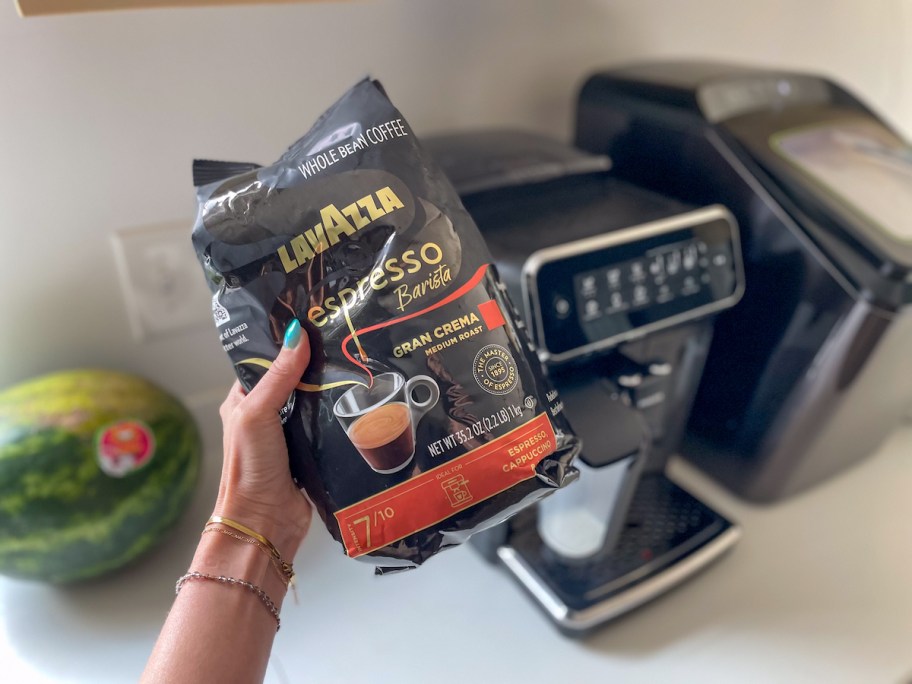 hand holding a bag of Lavazza Espresso Barista Gran Crema Whole Bean Coffee Blend 