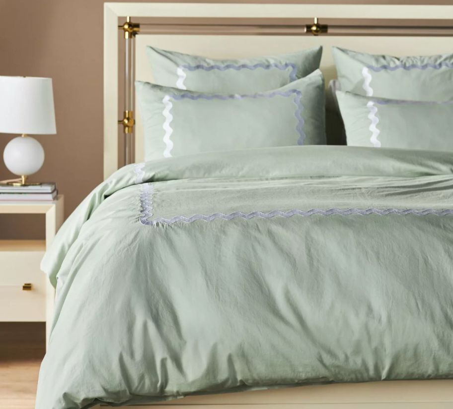 a mint colored satin duvet cover and shams