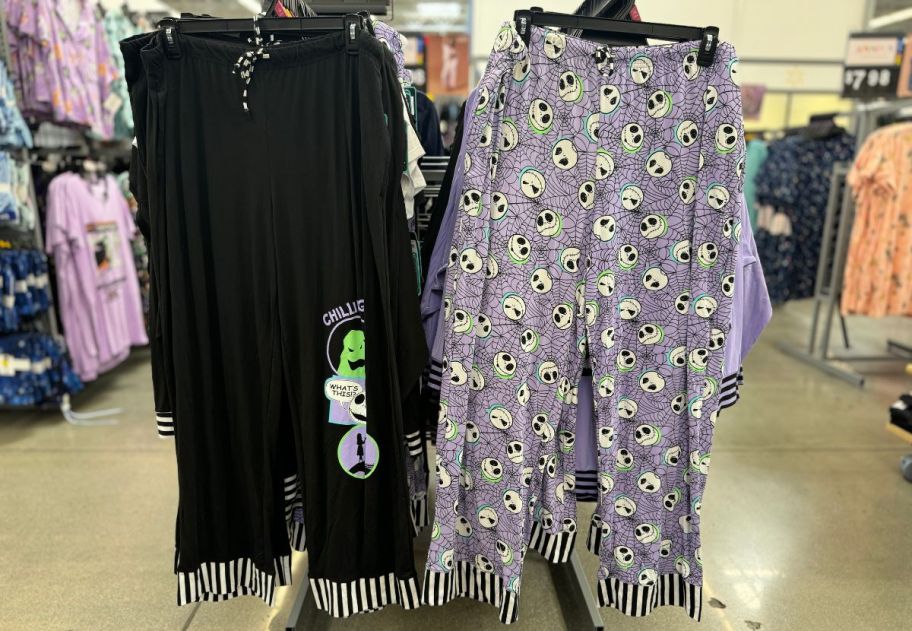 two pair of nightmare before chirstmas sleep pants on a rack in a walmart store.