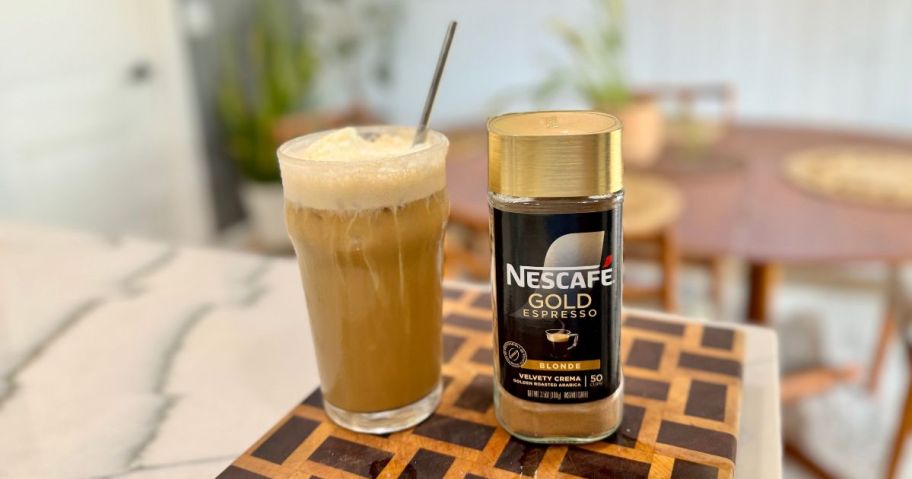 NESCAFÉ Gold Espresso Blonde Instant coffee canister next to a yummy-looking iced coffee