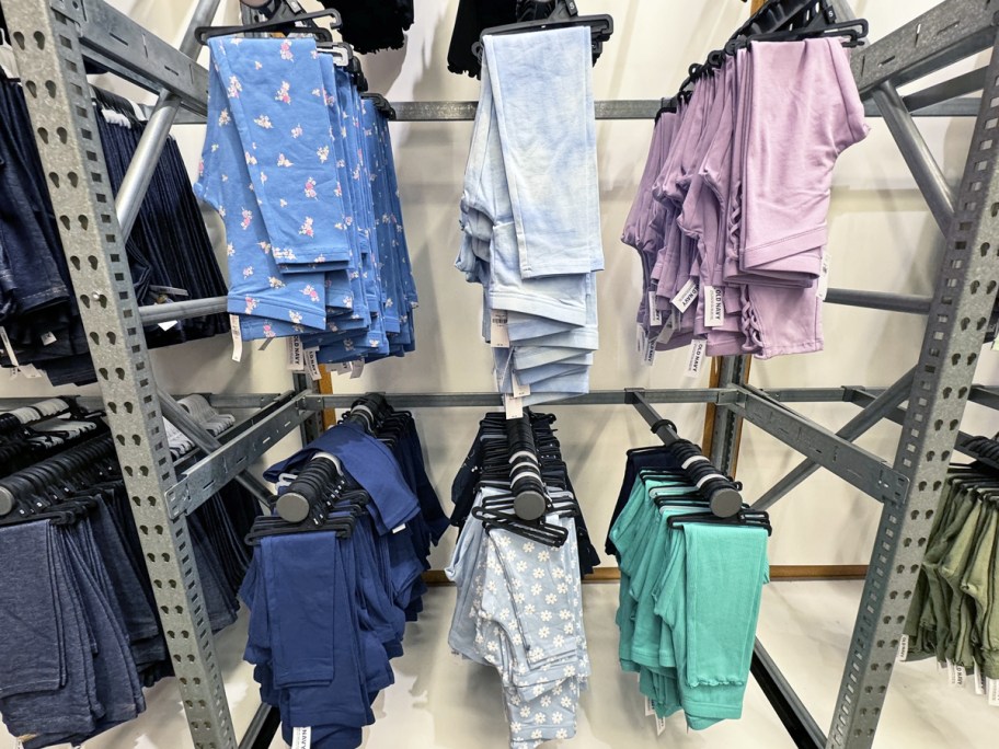 girls leggings on hangers on store display