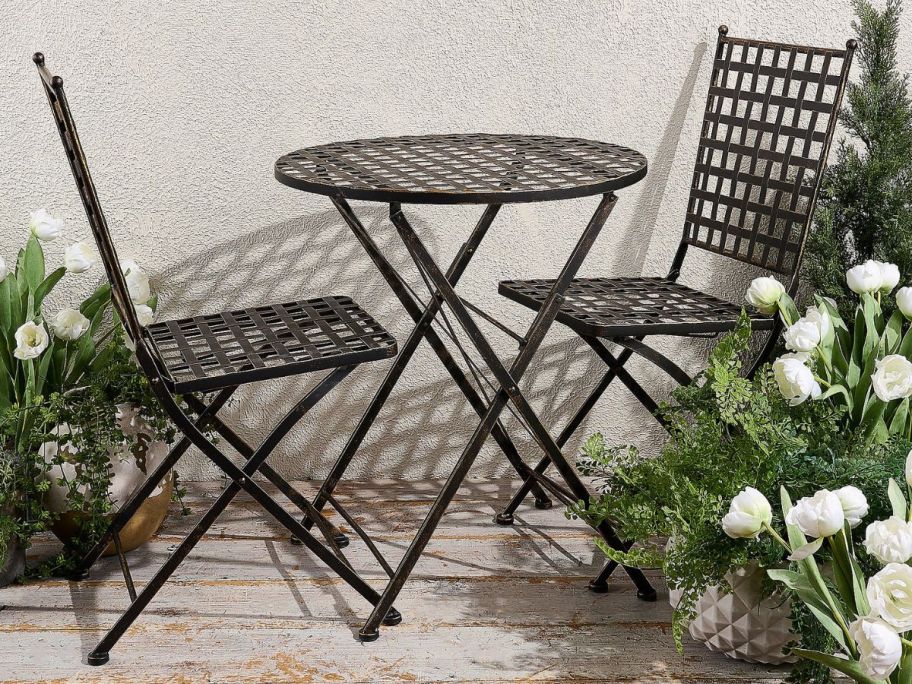 A folding metal bistro set from QVC on a patio