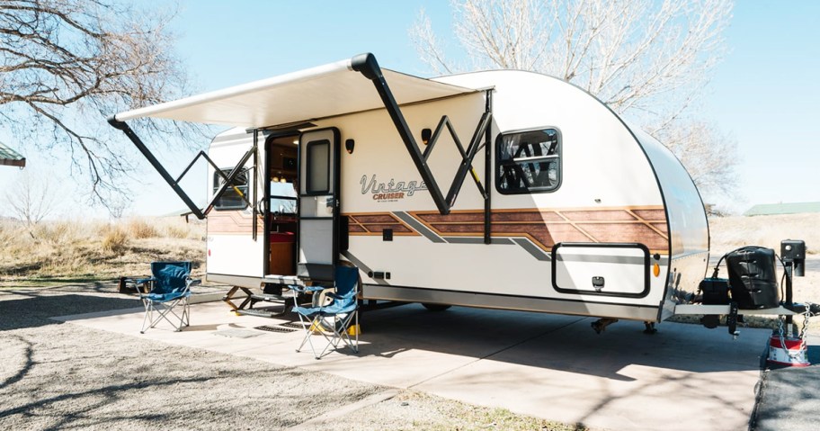 two camping chairs outside of an rv
