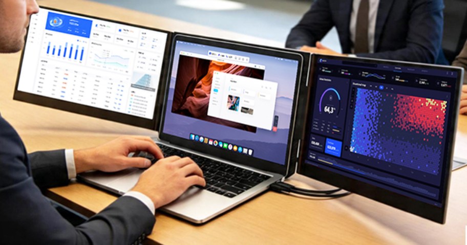 man working from a laptop with a dual screen extender added