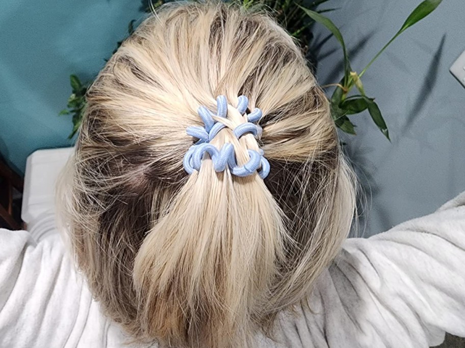 Woman wearing spiral scrunchie in light blue