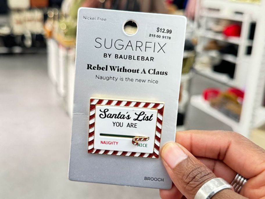 SugarFix by BaubleBar Rebel Without A Claus Brooch in hand in store