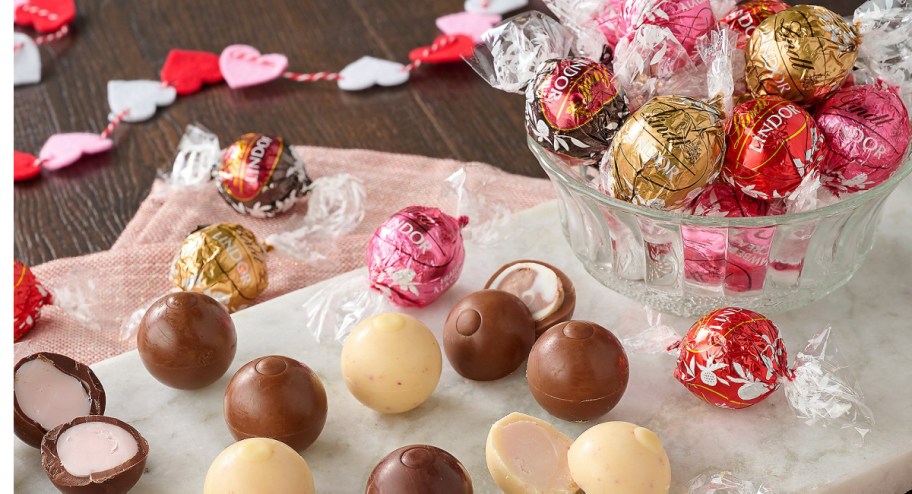 Valentine's day truffles inside of a bowl and displayed ont he side