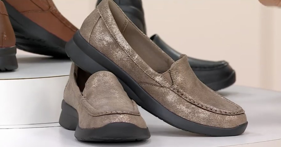 pair of women's slip on shoes in a shimmery light brown color