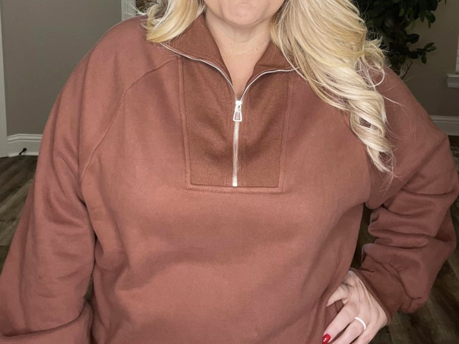 woman in brown half-zip sweatshirt