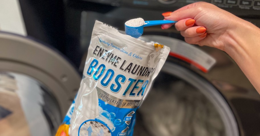 person scooping active laundry booster