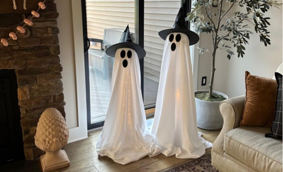 two sheet ghosts halloween decor in front of patio door