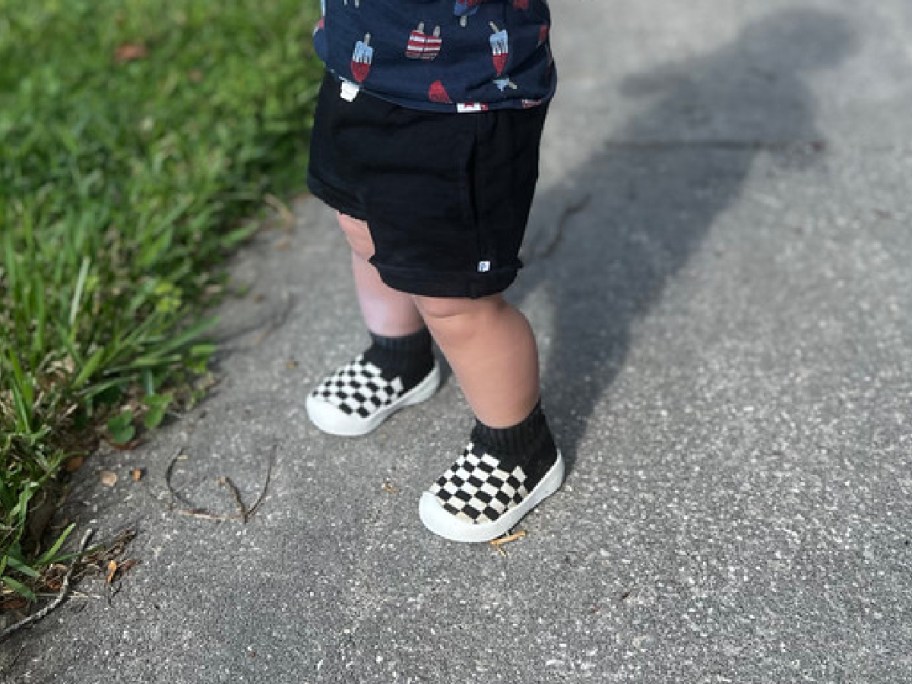 toddler wearing black and white checkered walking shoes