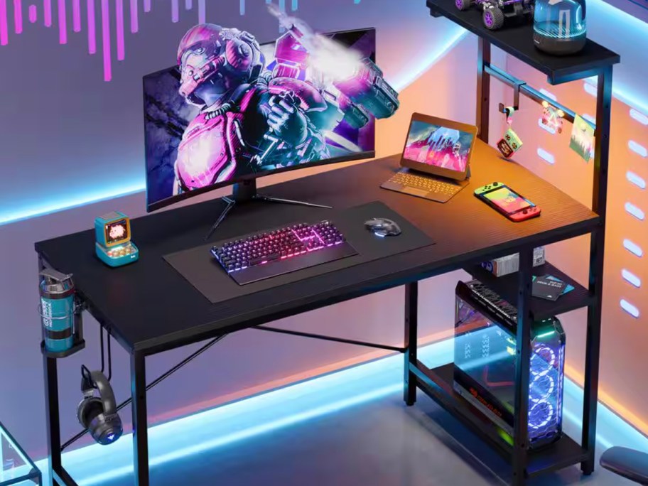 black gaming desk with computer on top and lights 