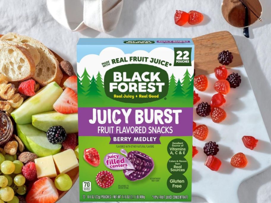 box of Black forest fruit snacks near table of snacks