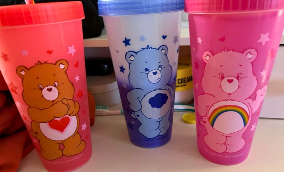 3 care bears tumblers on a kitchen counter