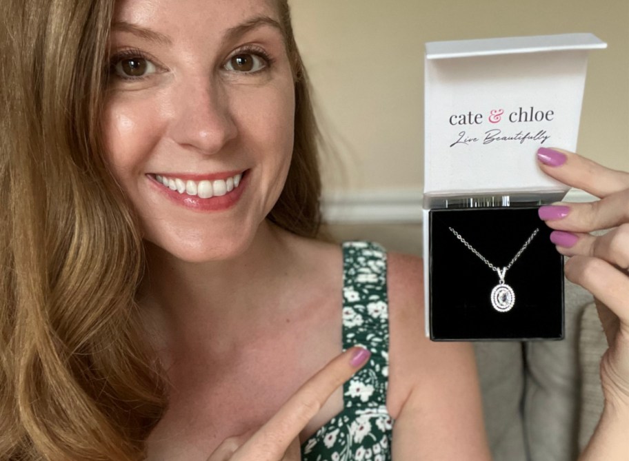 woman pointing at necklace in gift box