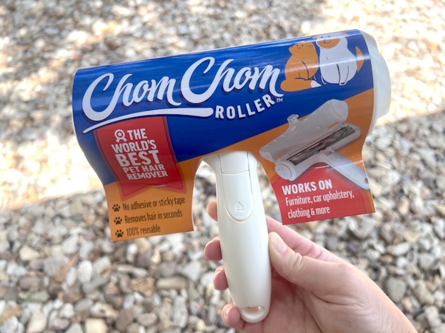 hand holding chom chom lint roller with packaging 