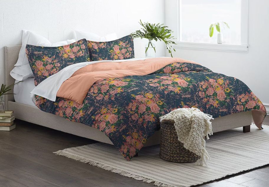 a green and peach 3 piece comforter set on a bed. 