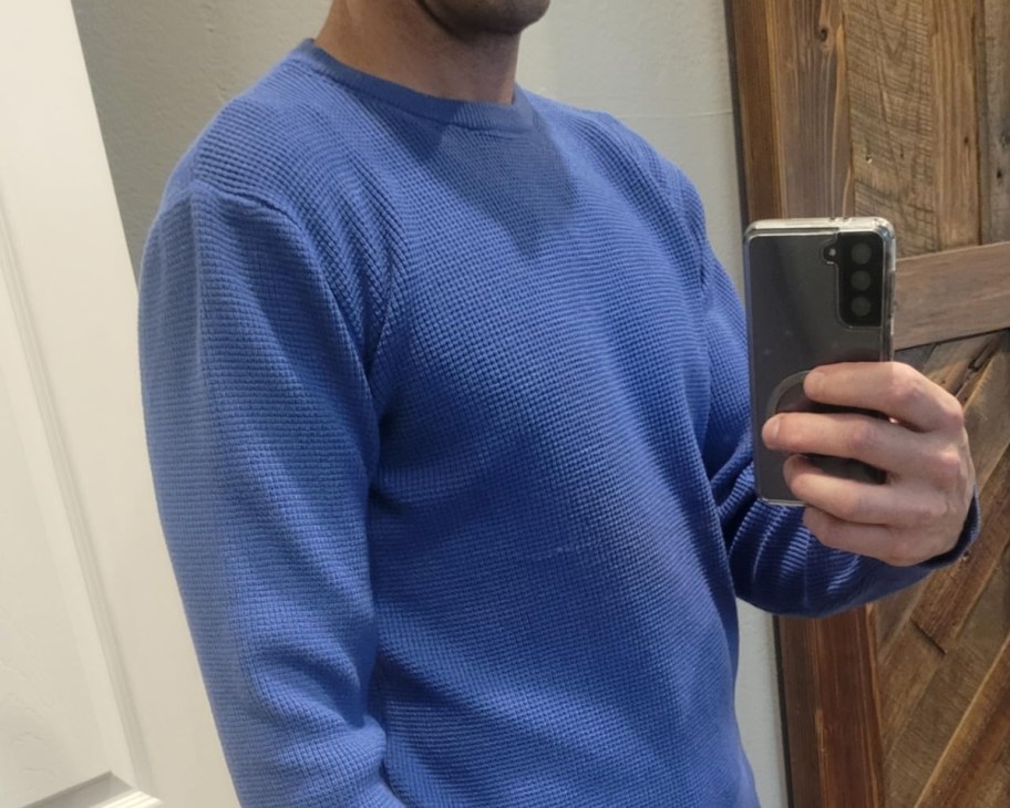 man taking selfie in blue sweater