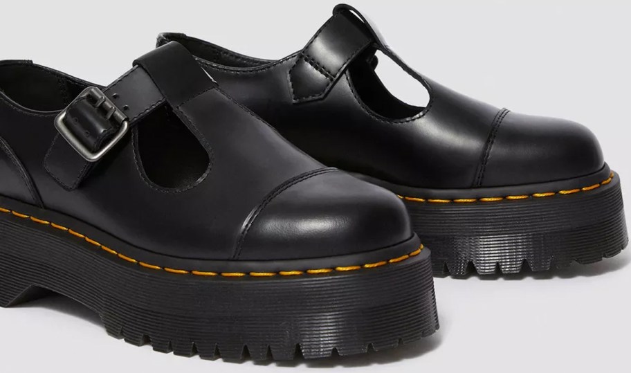 pair of black dr martens shoes 