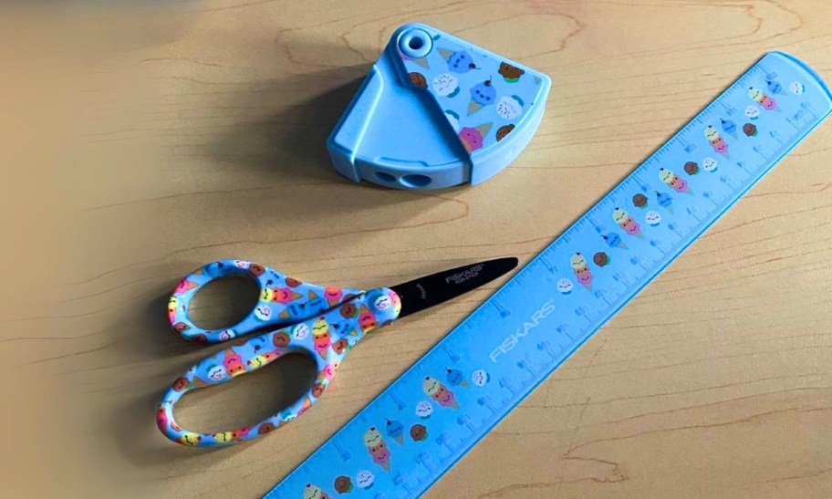 a 3 piece school set that includes kids safety scissors, a ruler, and a pencil sharpener