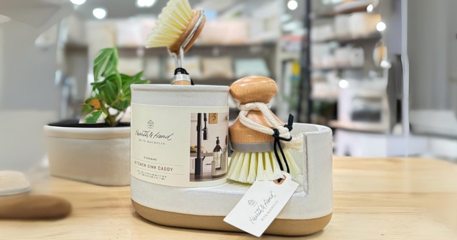 a stoneware sink caddy with a brush and scrubber brush on display at Target