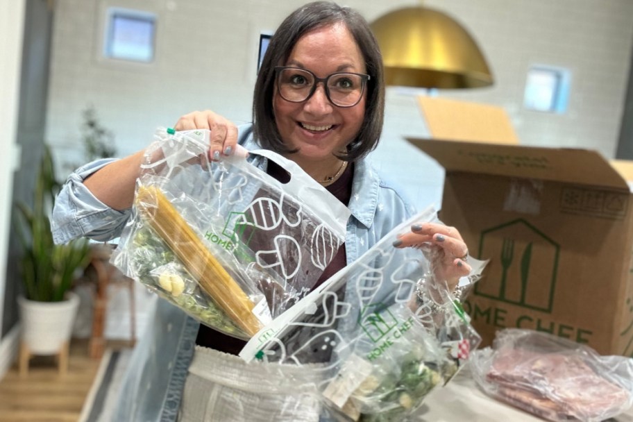 woman holding up home chef pre bagged foods