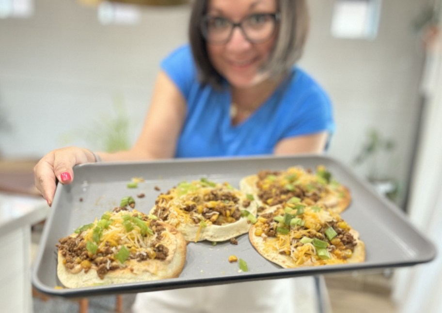 lina holding tray of tostadas