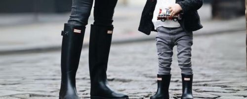 woman and kid wearing hunter boots outside