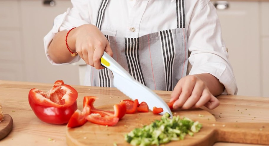 kid cutting veggies with knife