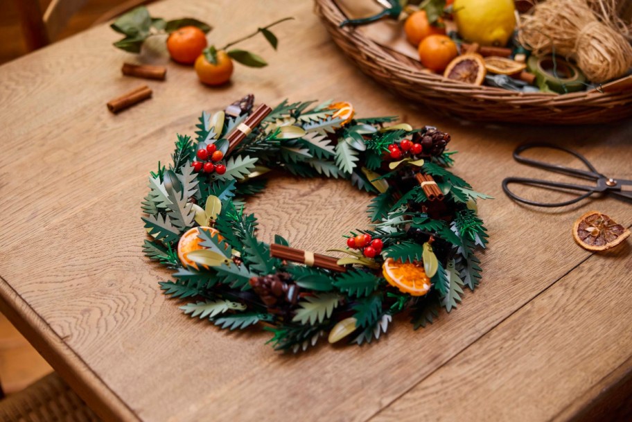 assembled lego icons wreath on a table near other seasonal greenery