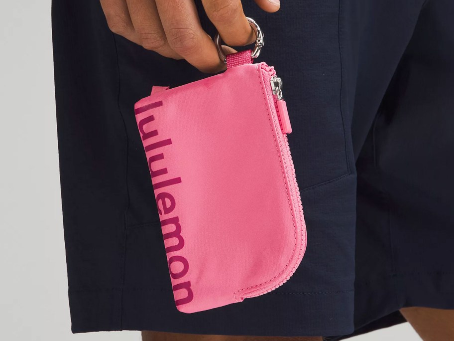 person holding a pink lululemon Clippable Card Pouch