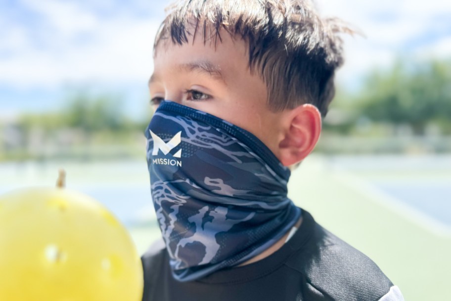 boy wearing camo cooling gaiter over face