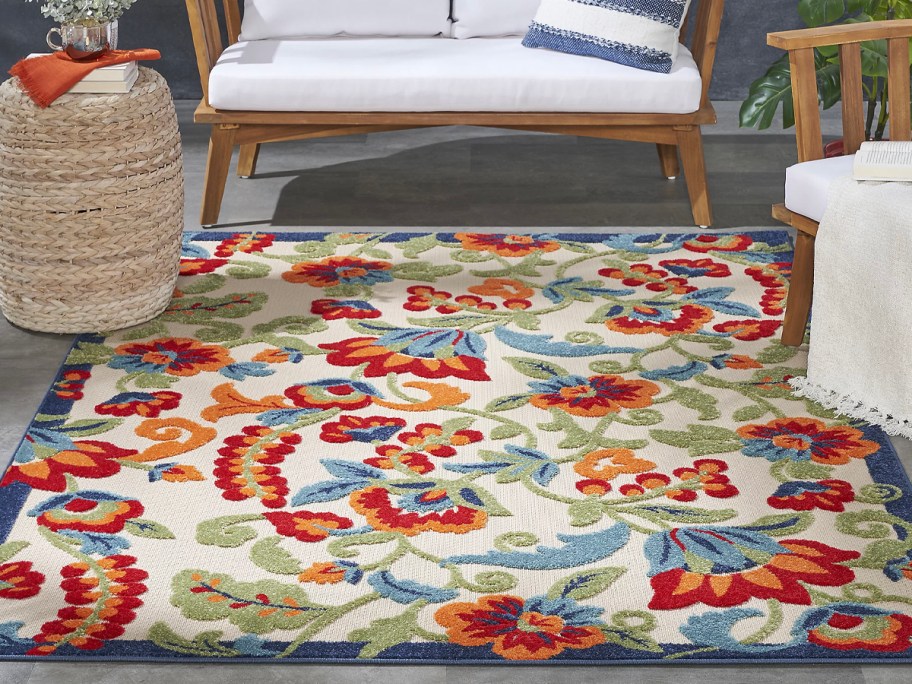 colorful floral rug next to outdoor couch 