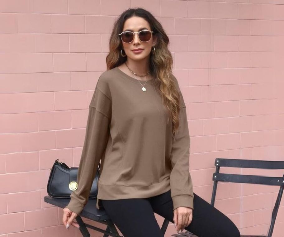 a woman in a brown cropped crewneck sweatshirt