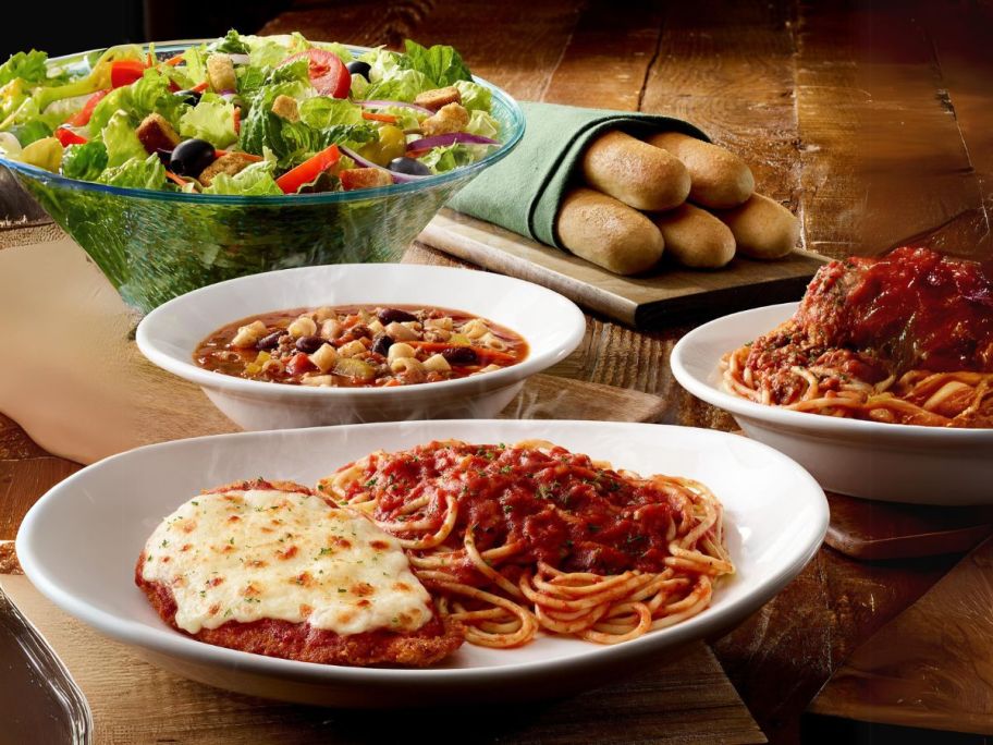 olive garden's salad, breadsticks, soup, and pasta bowls on table