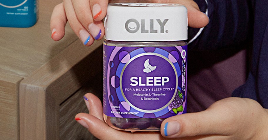 hands holding olly sleep bottle