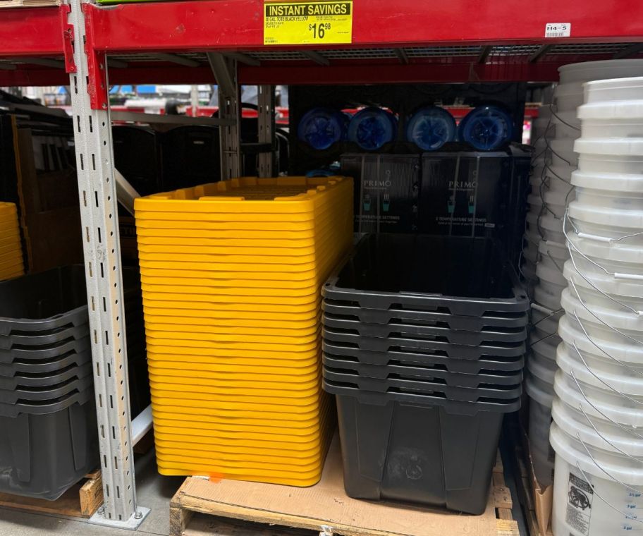 Storage totes and lids are stacked on Sams store shelves.