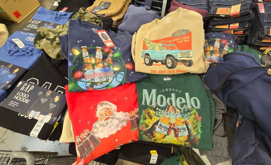 fours mens logo holiday sweatshirts on a display table in a store