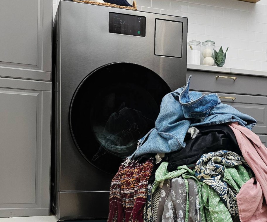 pile of laundry in front of washer/dryer combo