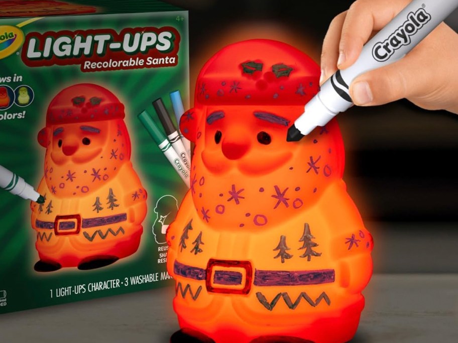 kid coloring on santa crayola light up toy