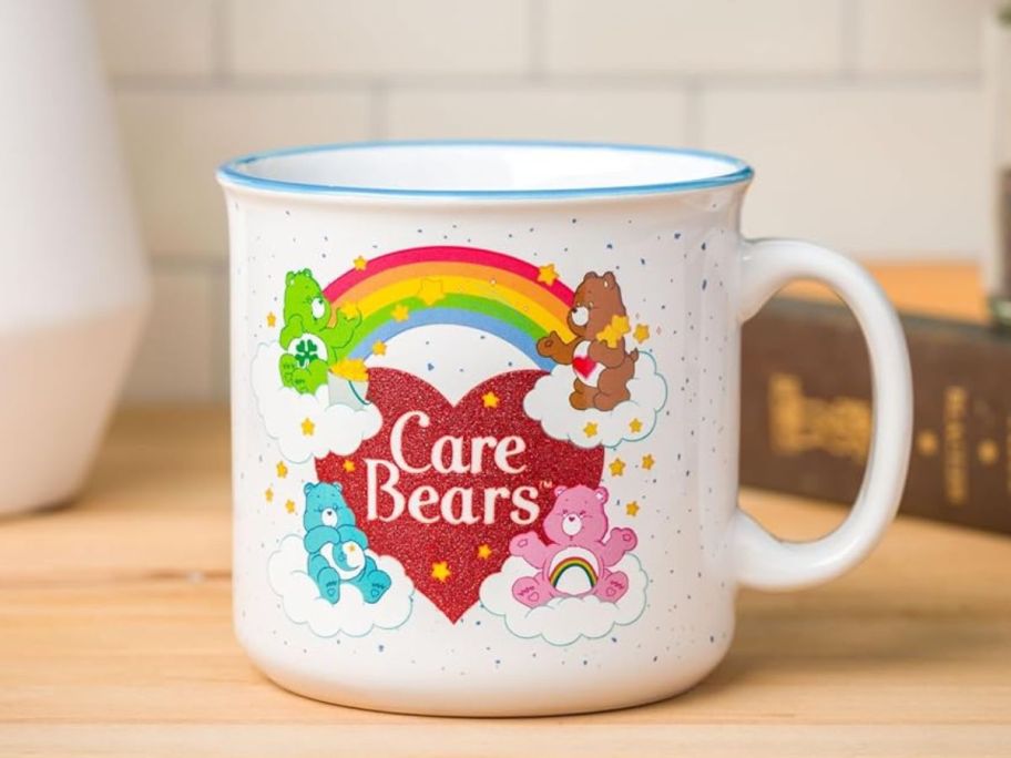 Silver Buffalo Care Bears Rainbow Heart Ceramic Camper Mug 20oz on counter