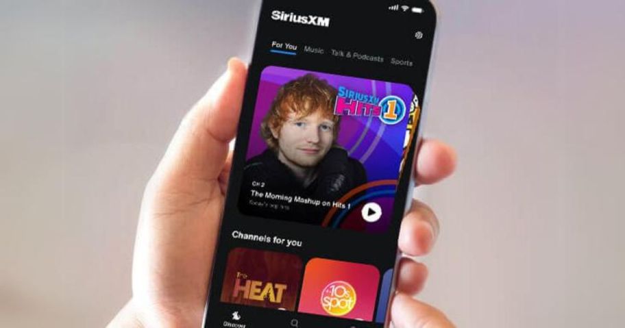 hand holding phone with siriusxm app on it