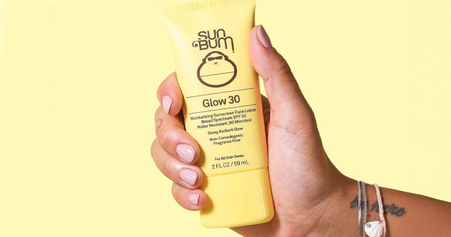 hand holding sun bum sunscreen 