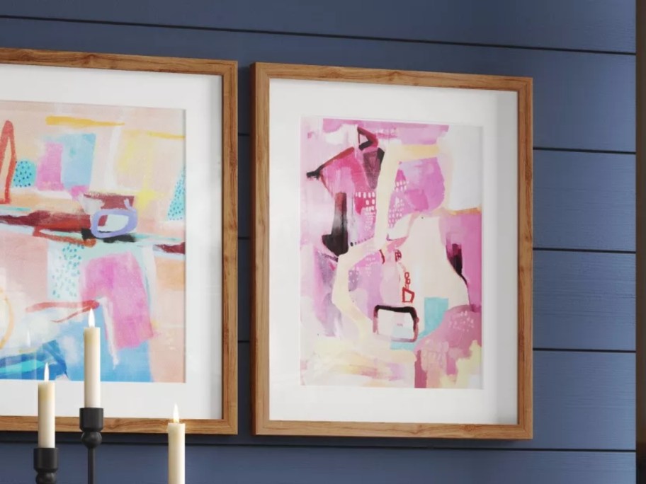 two framed wall art pieces with an abstract design on a wall