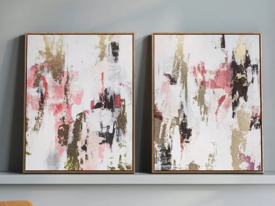 two framed wall art pieces with an abstract design on a wall