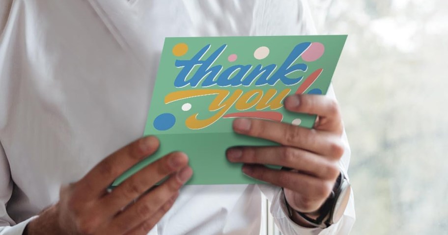 hand holding thank you card