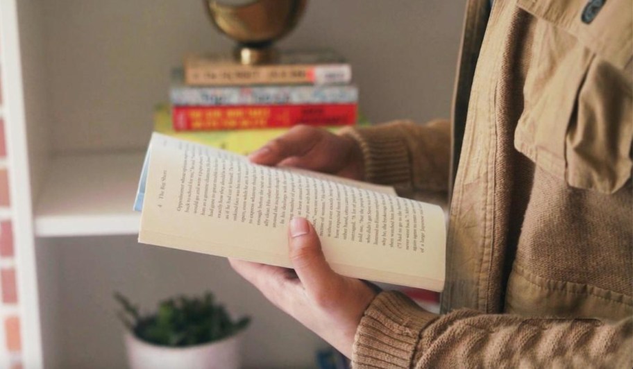 hands holding book open