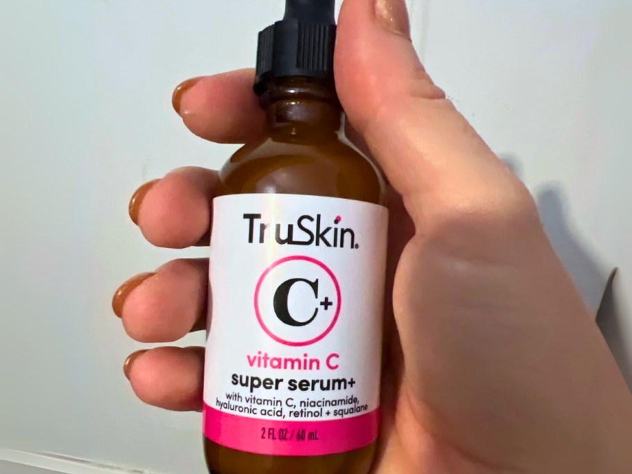 hand holding a large bottle of TruSkin Vitamin C Super Serum